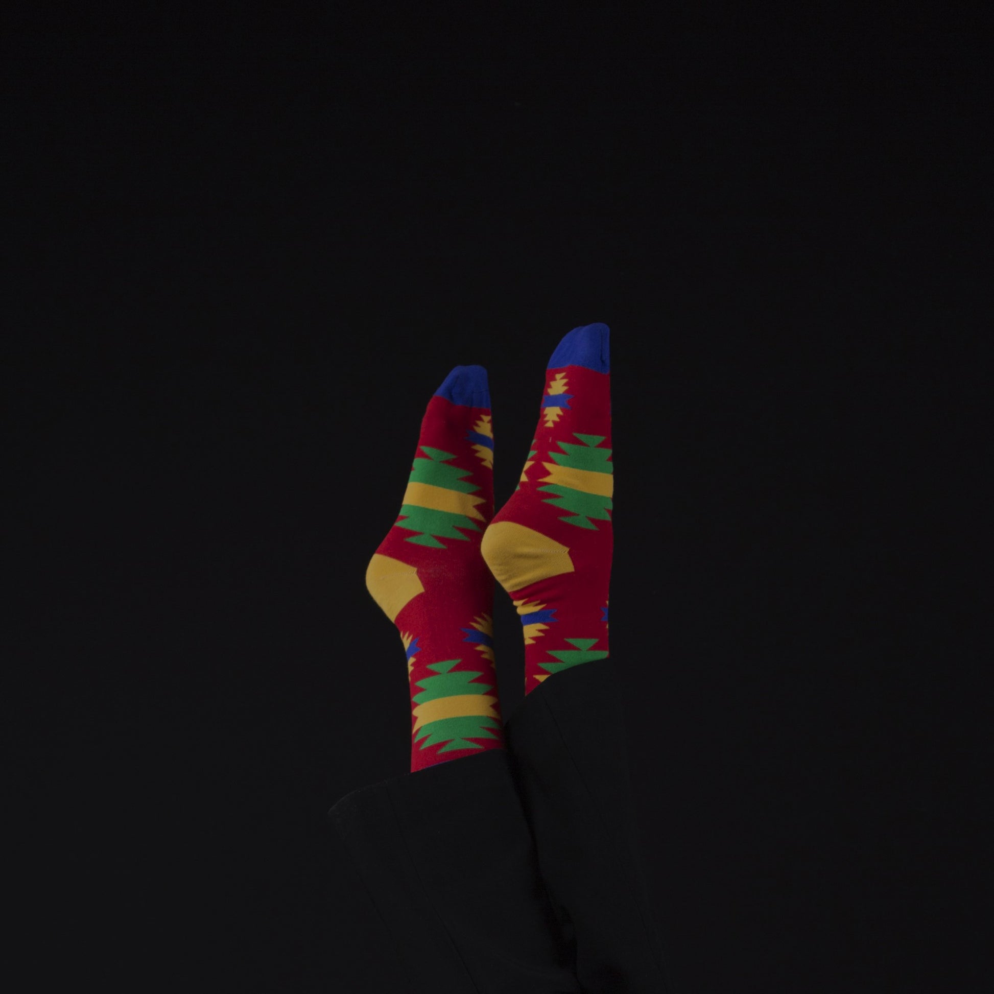 Old Traditions. Trendy way socks. Upside down black background.